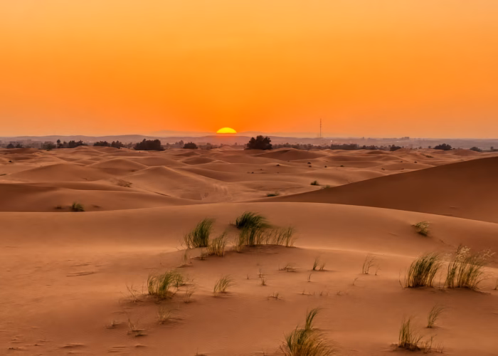 Sunset over the Sahara dunes during a 4 day Casablanca to Marrakech desert tour.